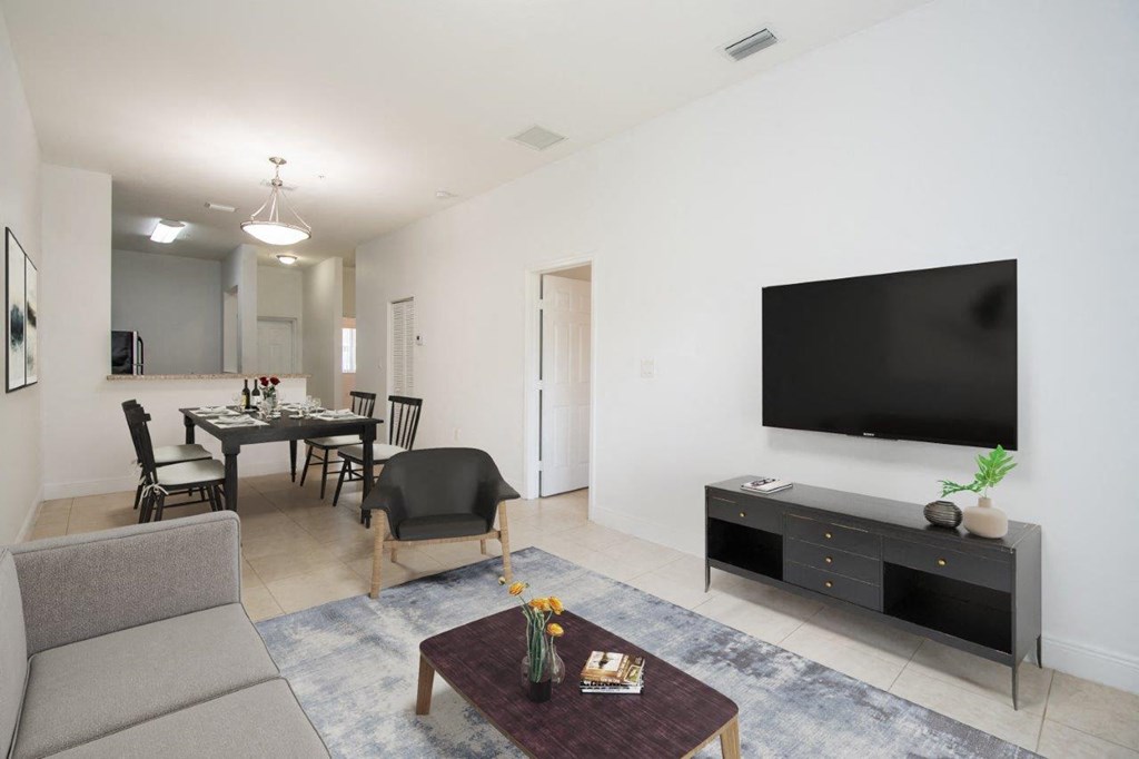 a living room and dining room with a television