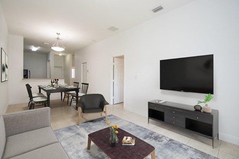a living room and dining room with a television
