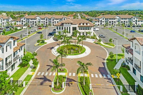 an aerial view of a street with houses and a fountain