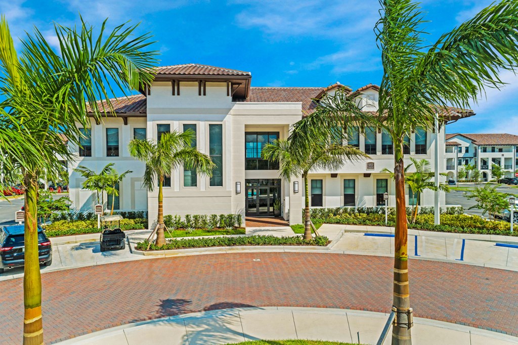 a large house with palm trees in front of it