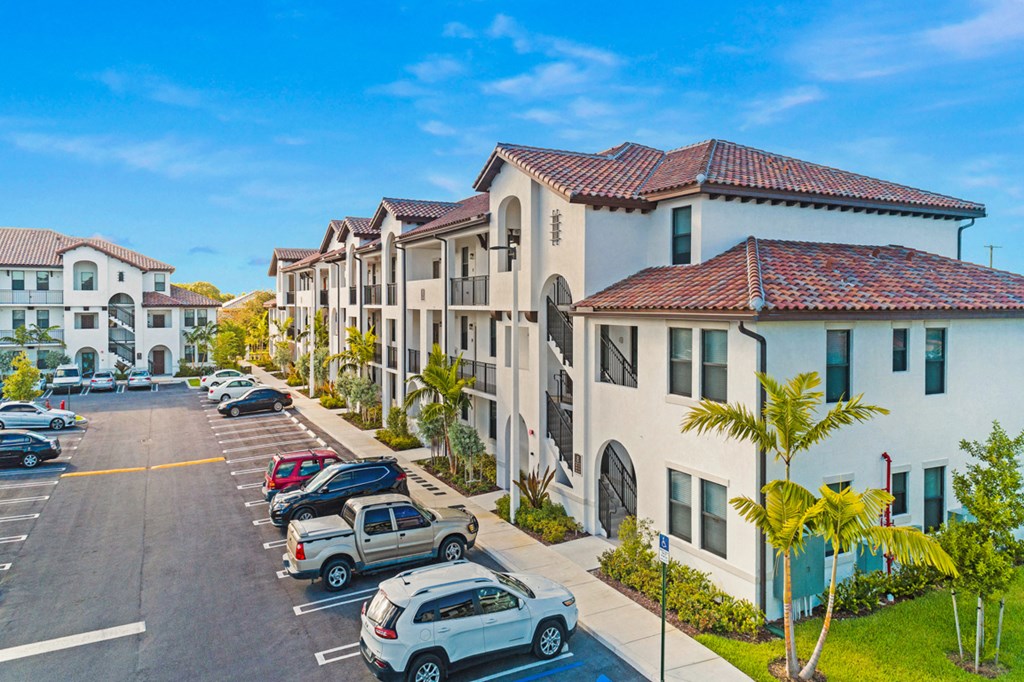 a row of houses on the side of a street with parked cars