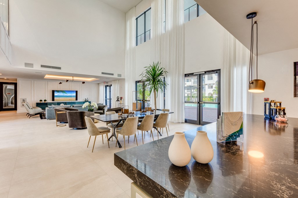 the living room and dining area of a house with high ceilings