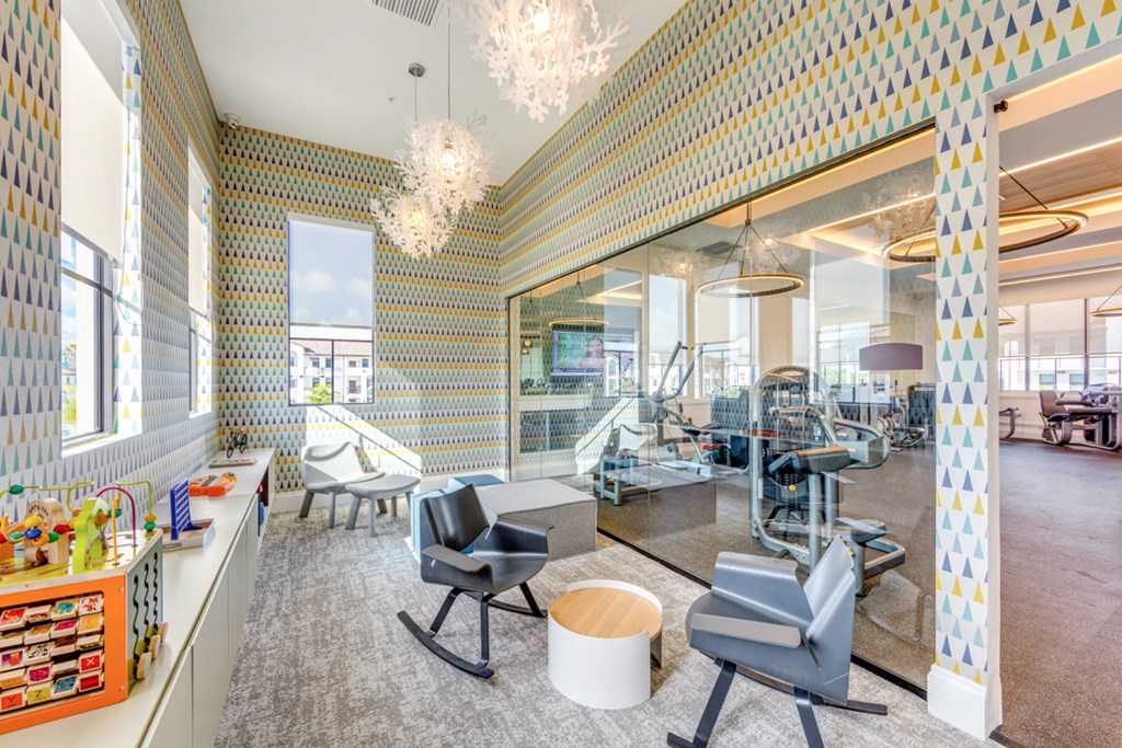 the lobby of a dental office with blue chairs and checkered walls