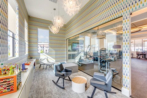 the lobby of a dental office with blue chairs and checkered walls