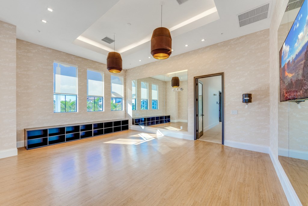 a large living room with a wood floor and large windows