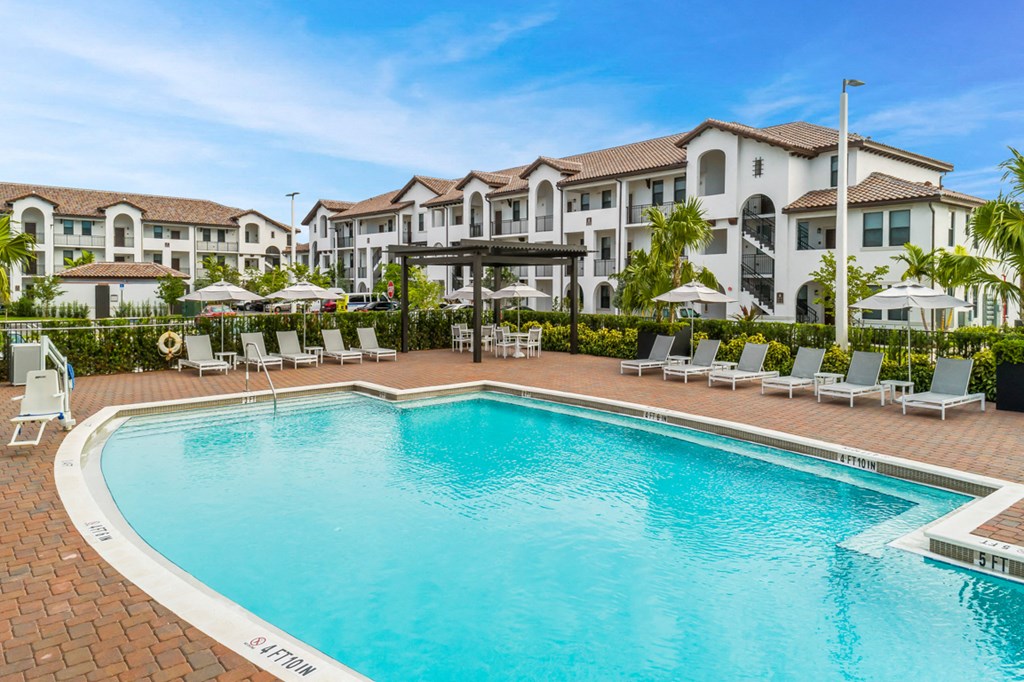 a swimming pool at an apartment complex with a resort style pool