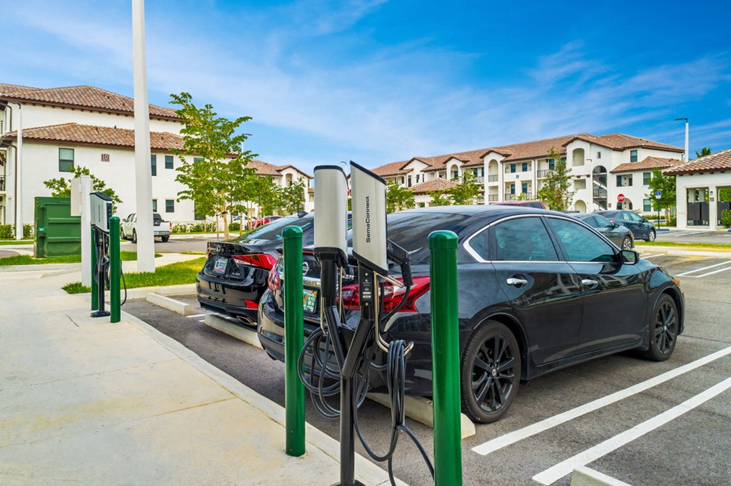 a car is plugged in to a electric charger in a parking lot