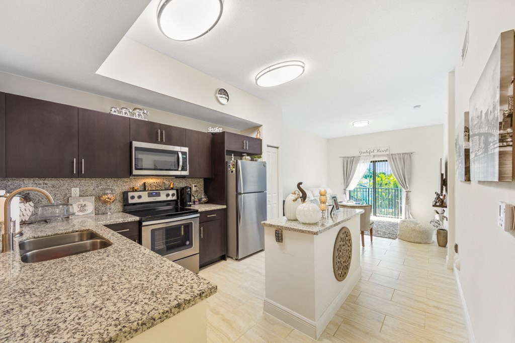 a kitchen with granite counter tops and stainless steel appliances