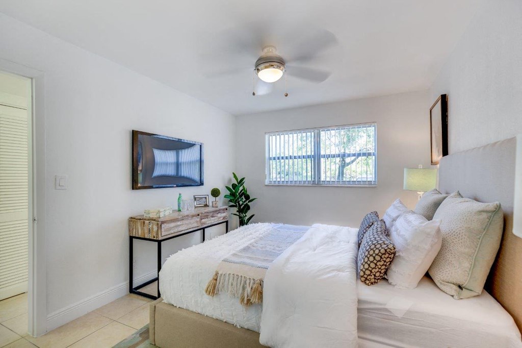 a bedroom with a bed and a tv