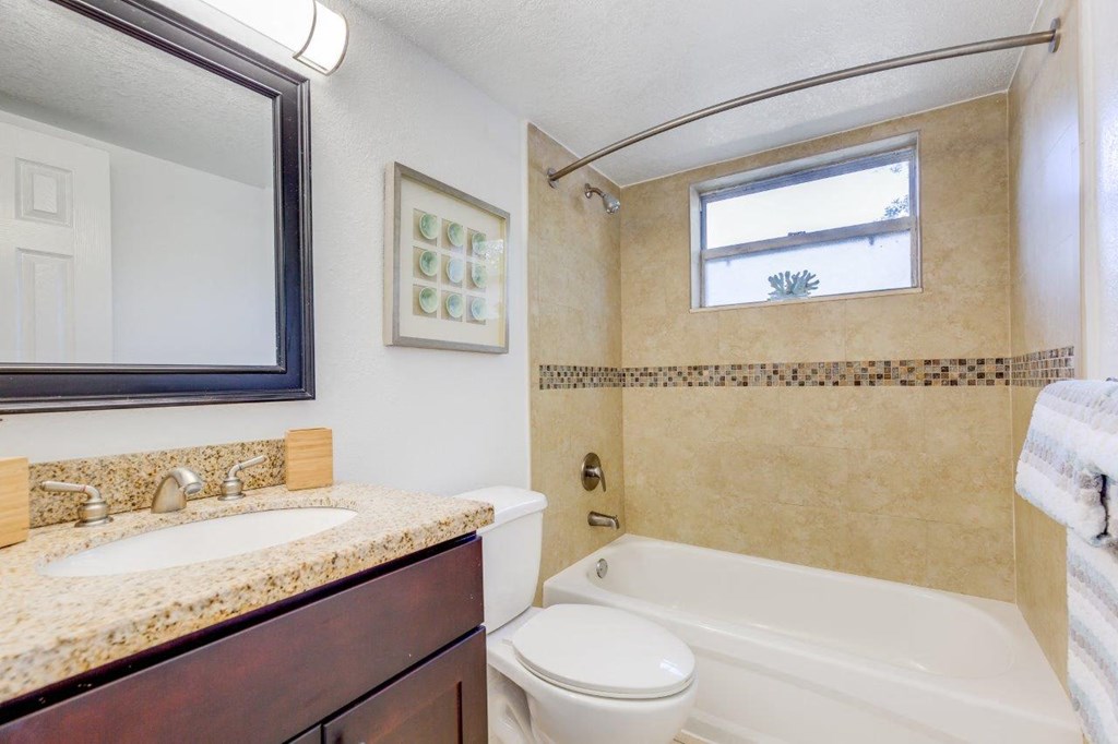 a bathroom with a sink toilet and a bath tub