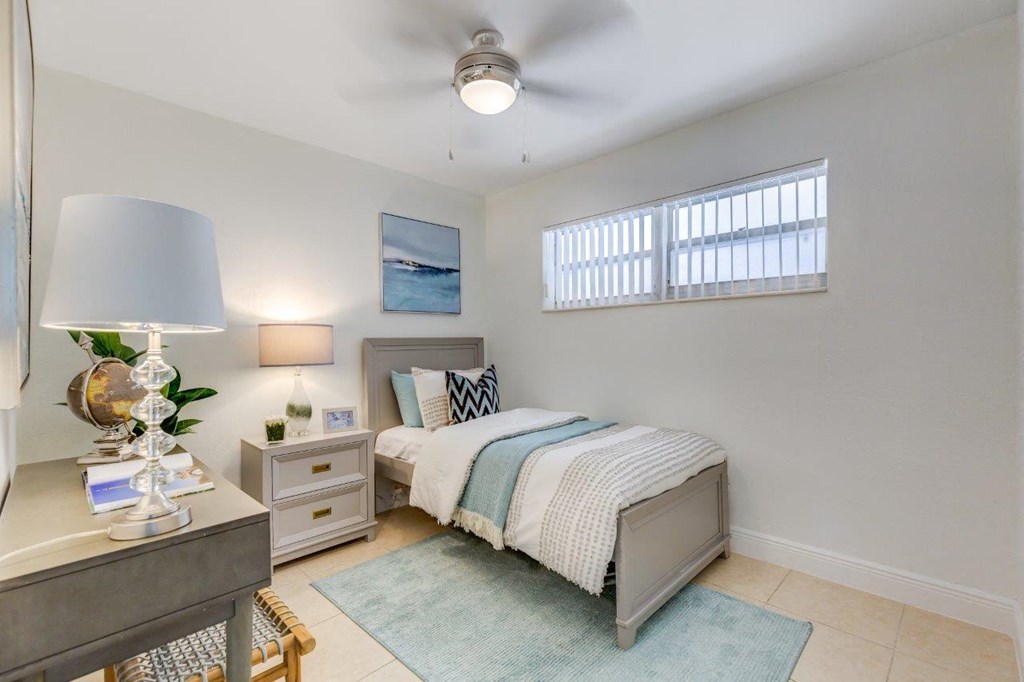 a bedroom with a bed and a desk