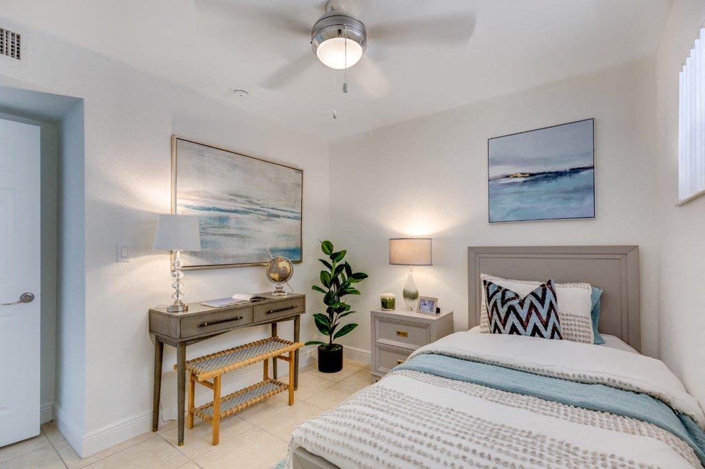 a bedroom with a bed and a desk