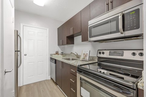 a kitchen with stainless steel appliances and a white door