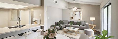 A modern living room with a grey couch and a coffee table.