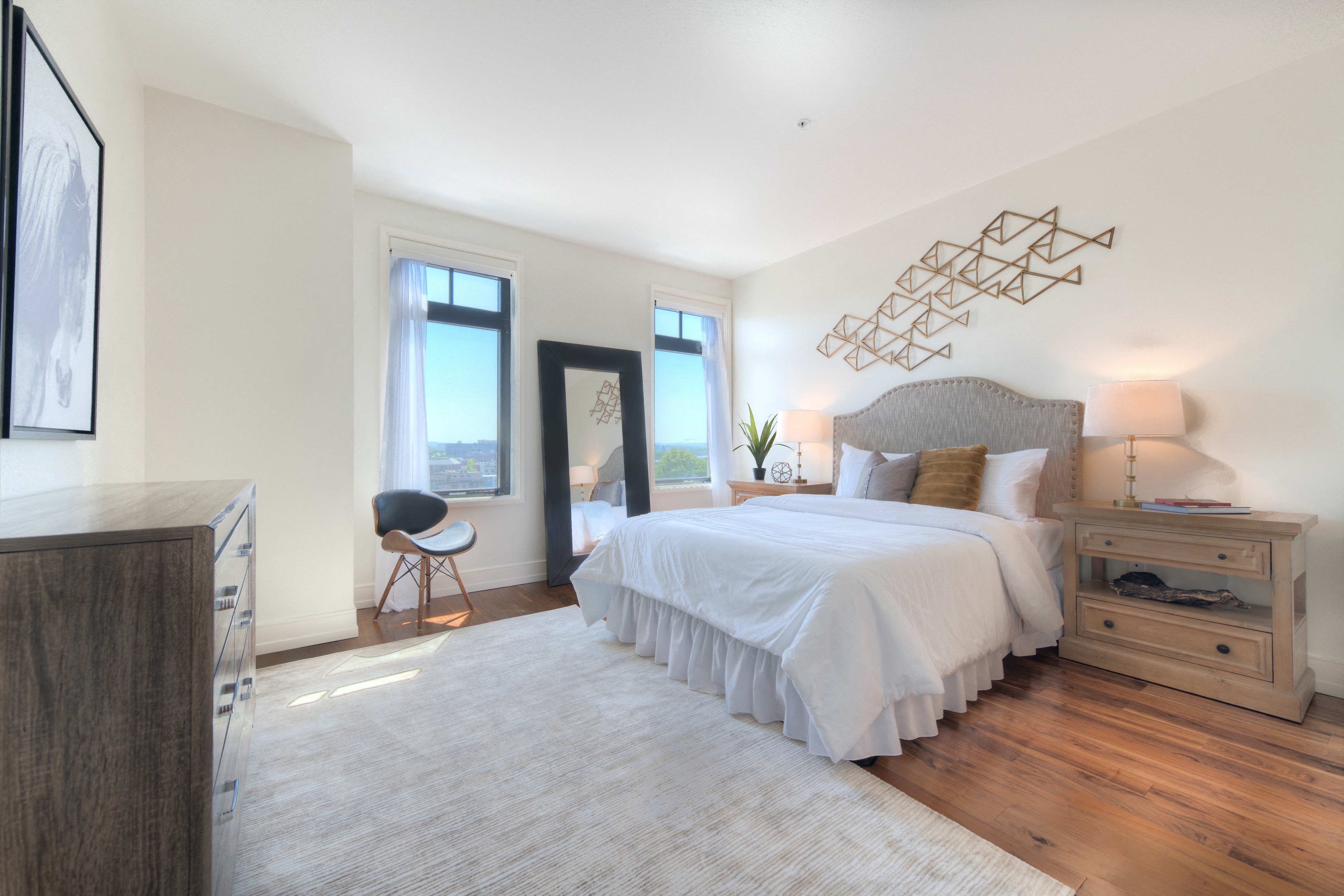 a bedroom with a bed and a dresser and a window