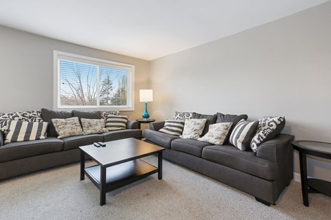 a living room with couches and a coffee table