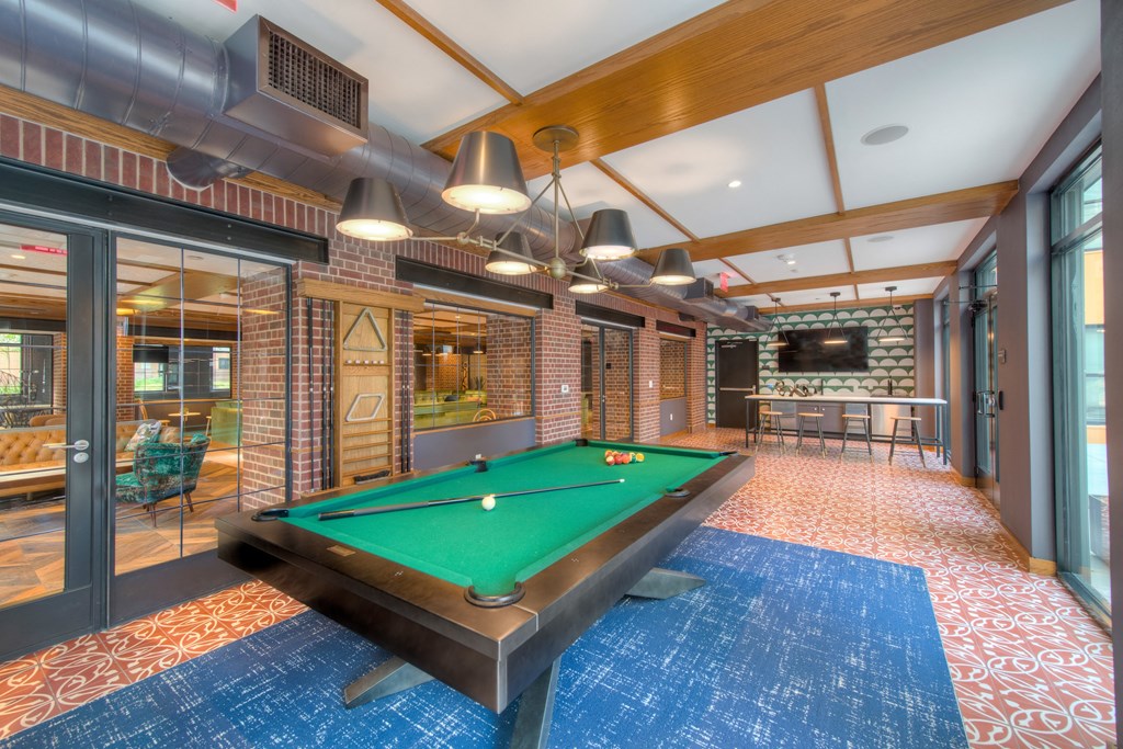Game room with a pool table and bar