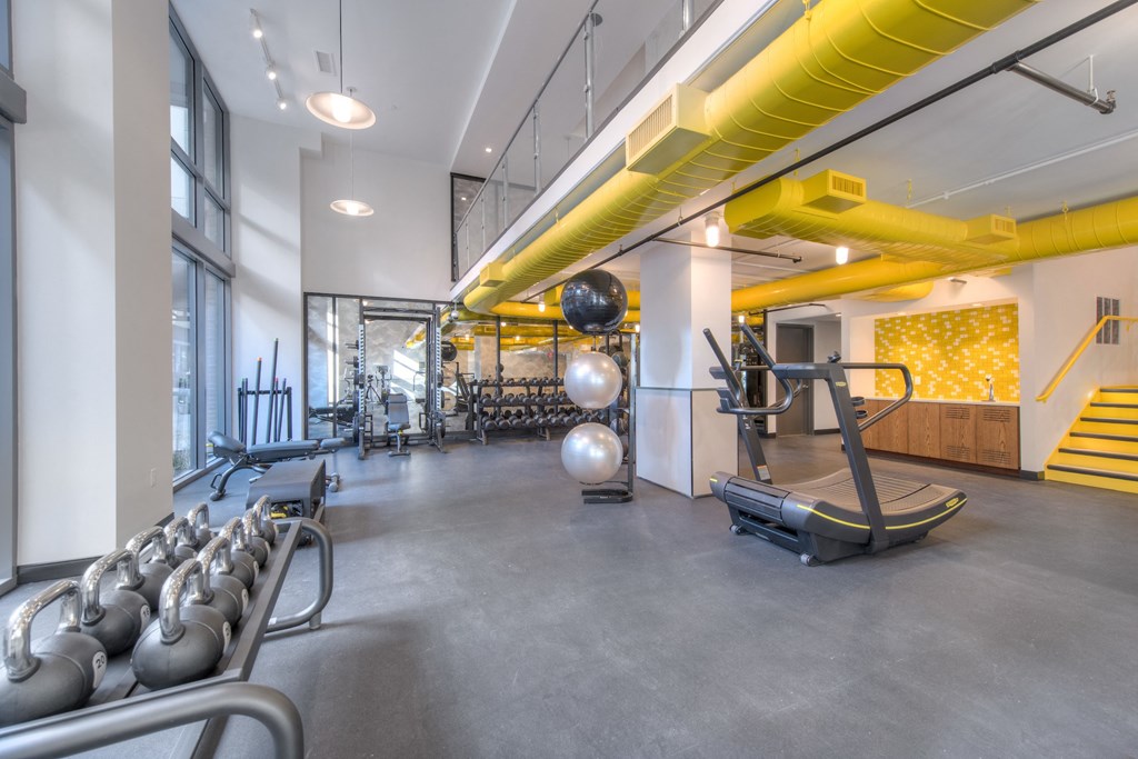 Gym space with treadmill and free weights