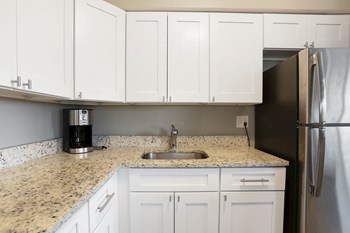 Kitchen with sink, coffee maker and cabinets - Photo Gallery 2