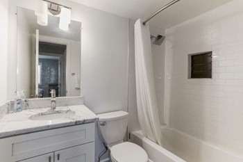 Bathroom with marble vanity and shower/tub combo