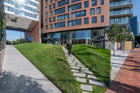 A modern building with a green lawn in front.