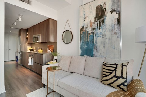 a living room with a couch and a painting on the wall