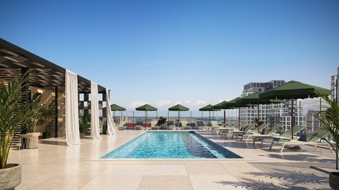 A large outdoor swimming pool with lounge chairs and umbrellas.