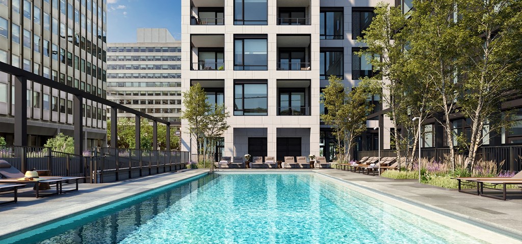 a swimming pool in front of a tall building