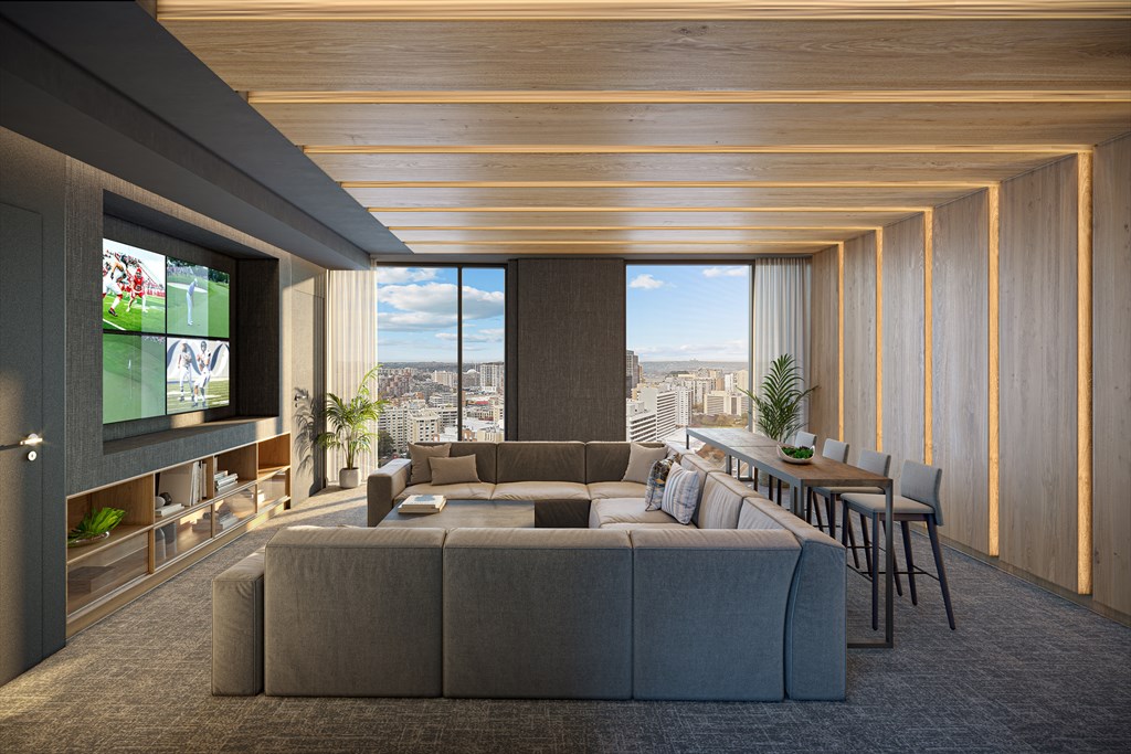 A modern living room with a large grey sofa and a television on the left side.