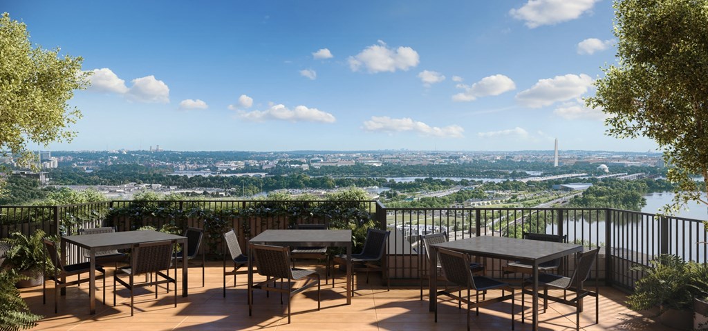 a patio with tables and chairs and a view of the city