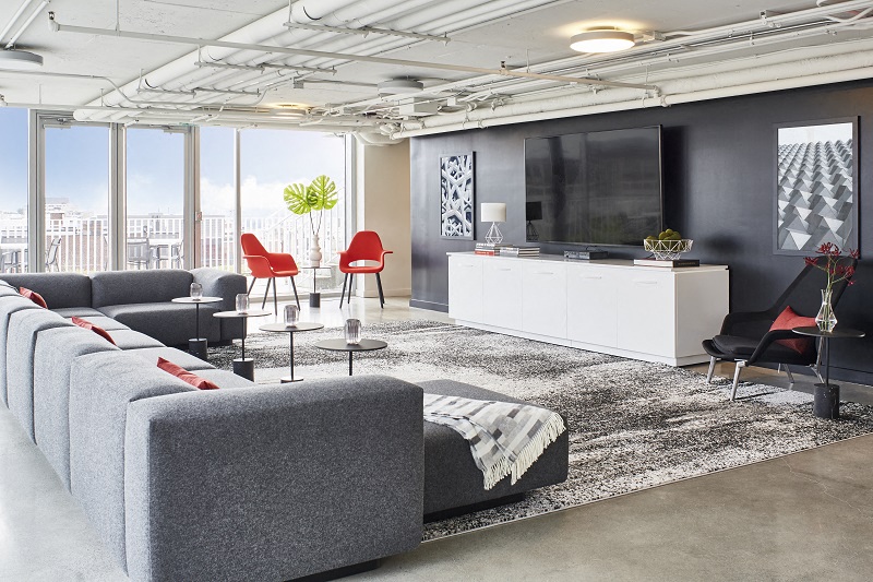 a living room with couches and a television in a loft