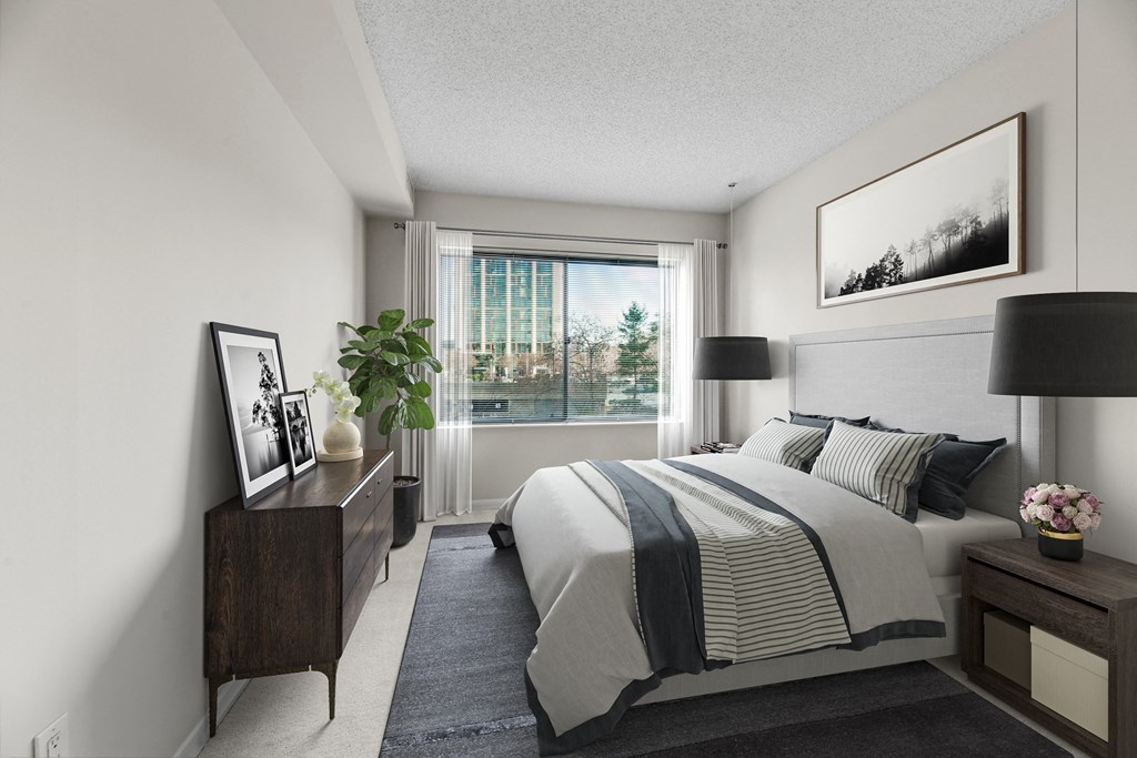 an apartment bedroom with a bed and a window