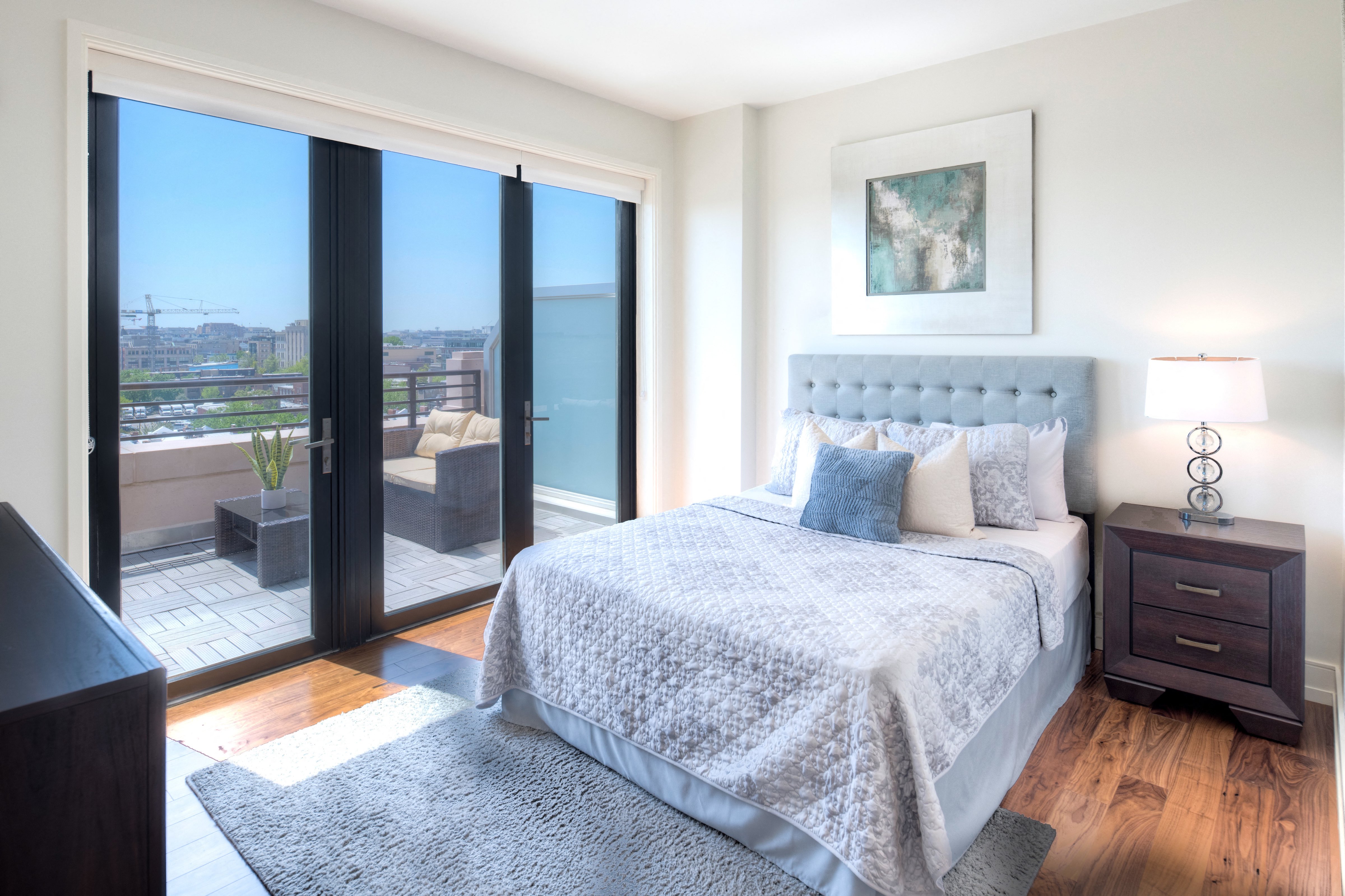 a bedroom with a bed and sliding glass doors to a balcony