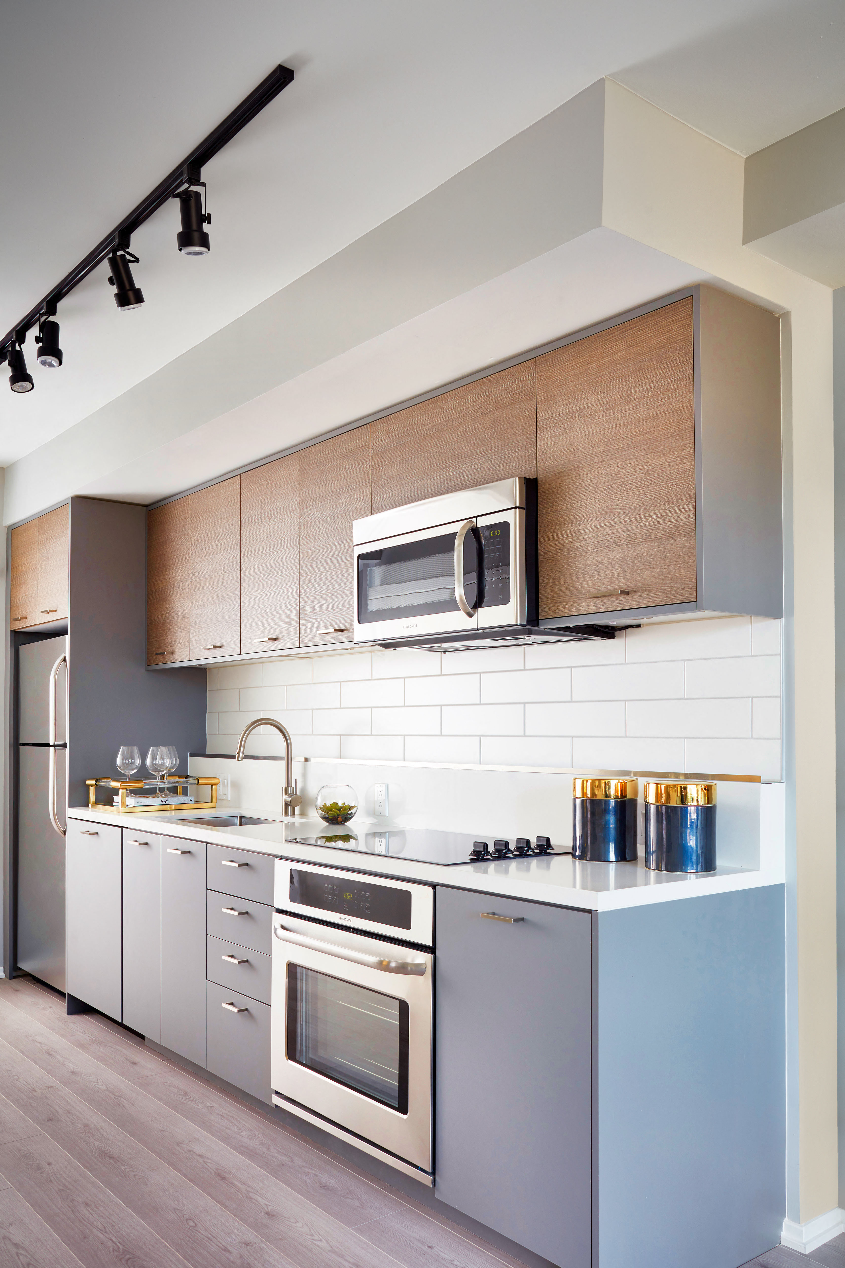 a kitchen with stainless steel appliances and wooden cabinets