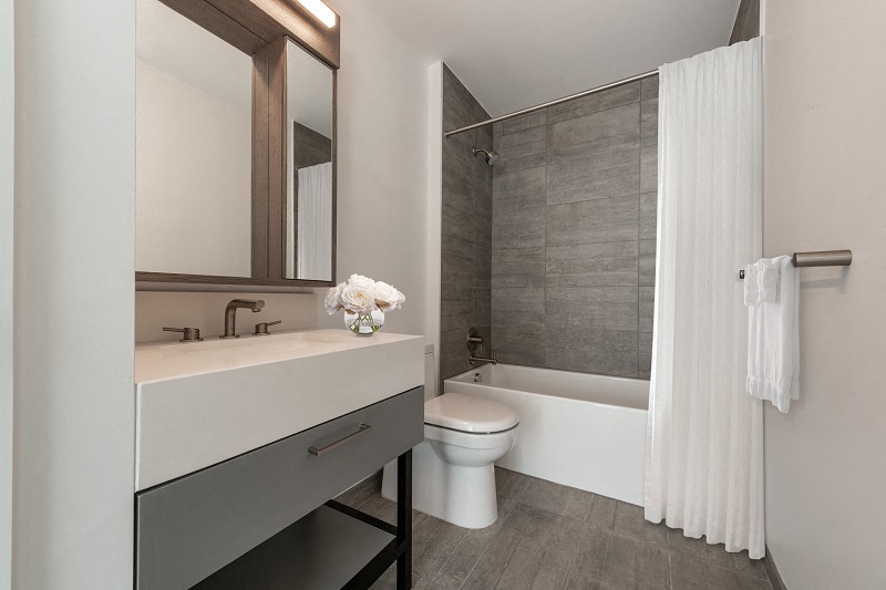 a bathroom with a toilet and a sink and a bath tub