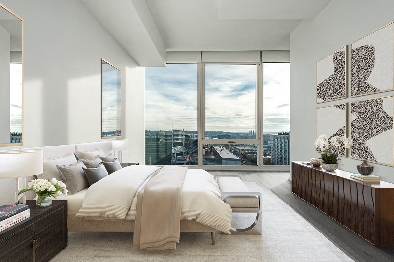 a bedroom with a bed and a view of the city