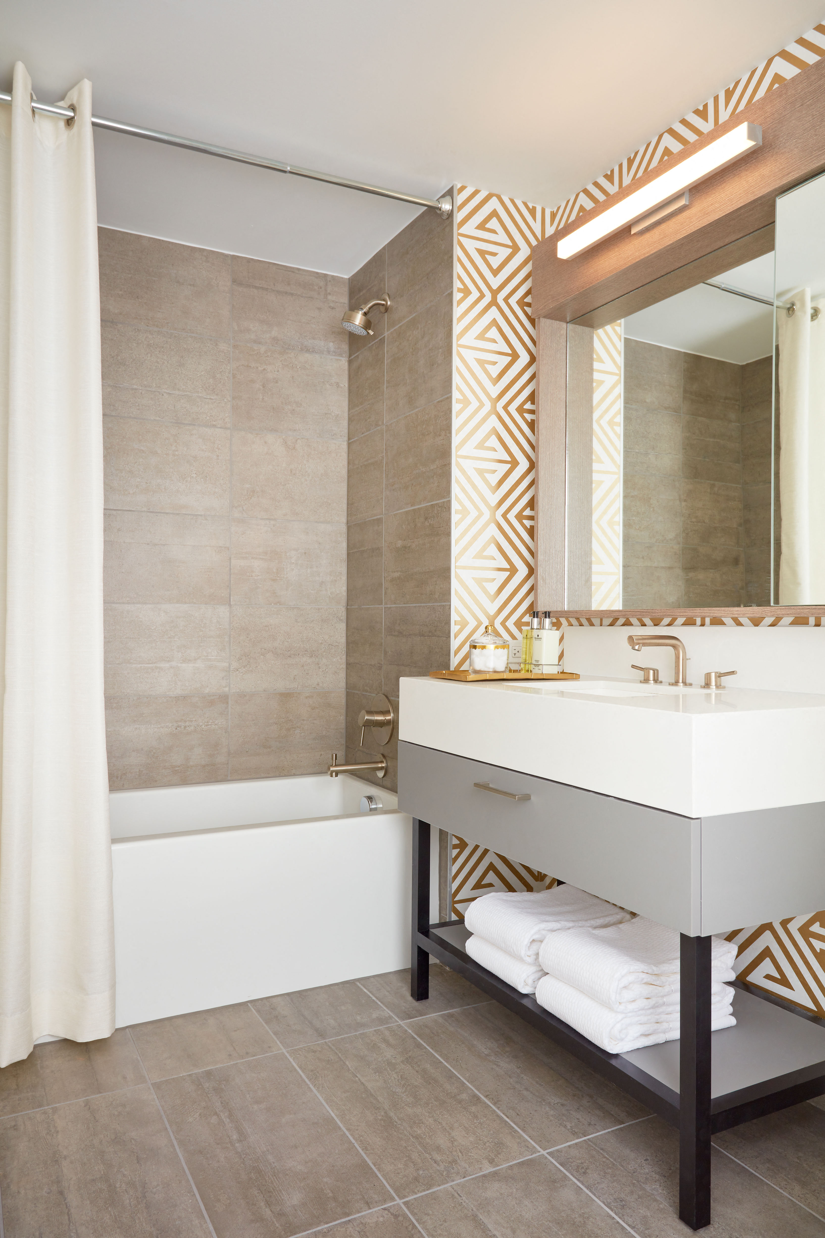 a bathroom with a sink and a tub and a mirror