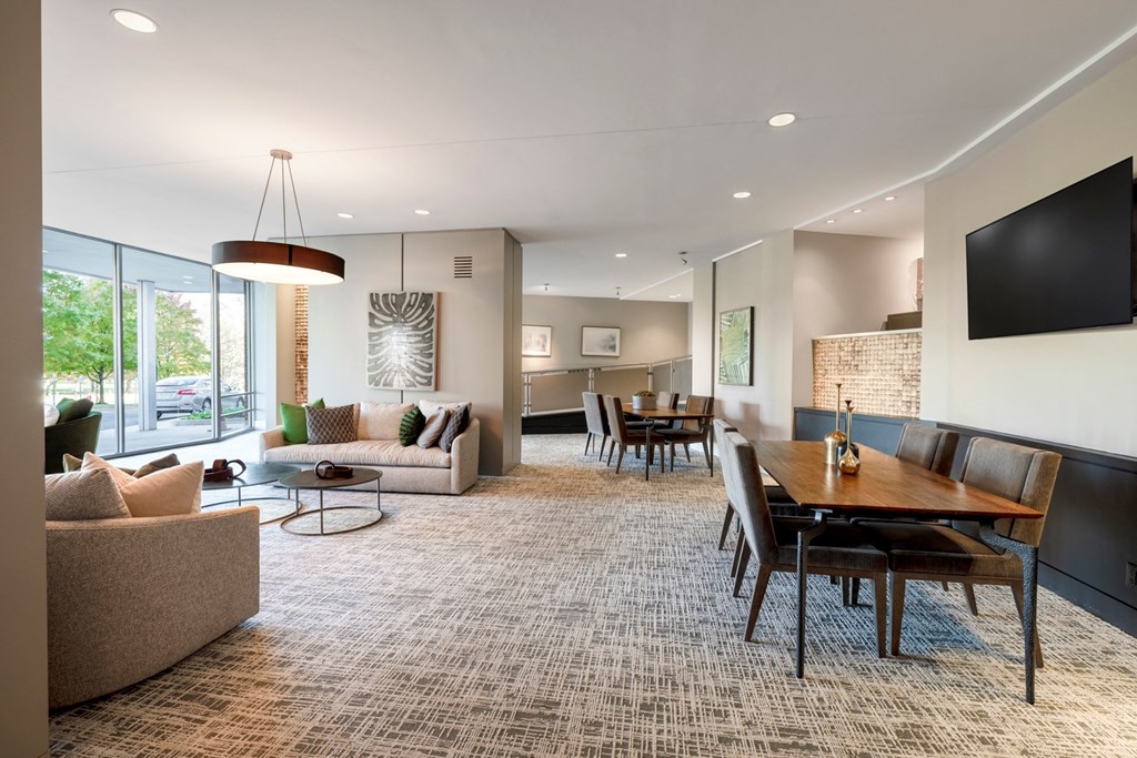 a living room and dining room with a table and chairs