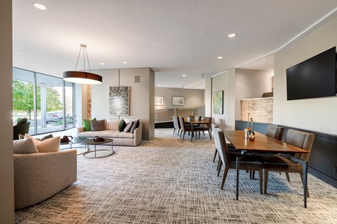 a living room and dining room with a table and chairs