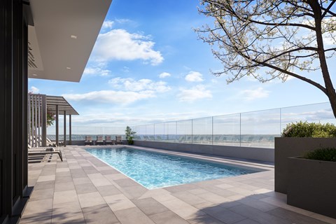 A modern pool area with a clear blue sky.