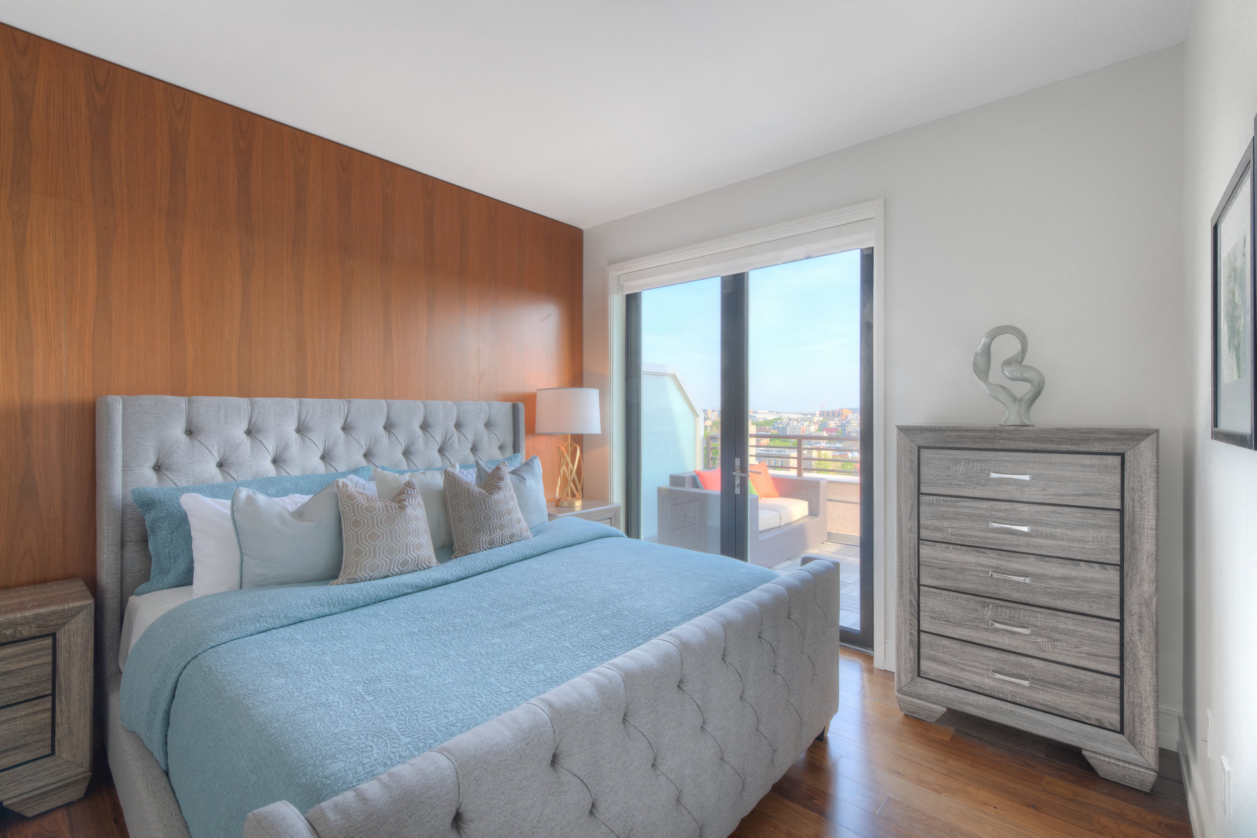 a bedroom with a bed and a door to a balcony