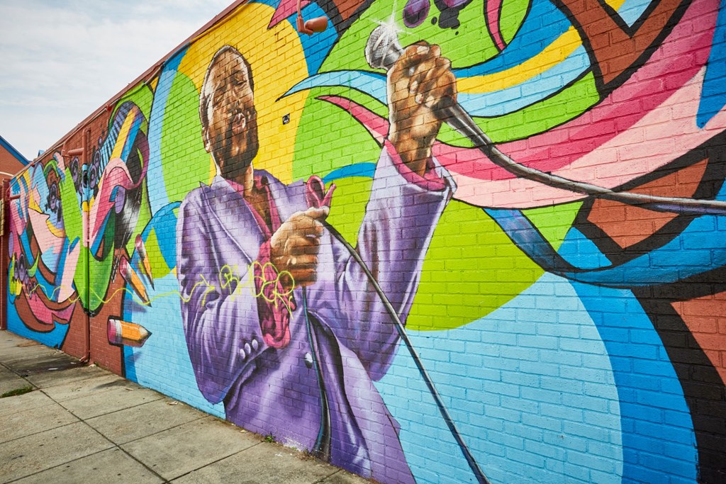 a mural on a wall of two women holding ropes