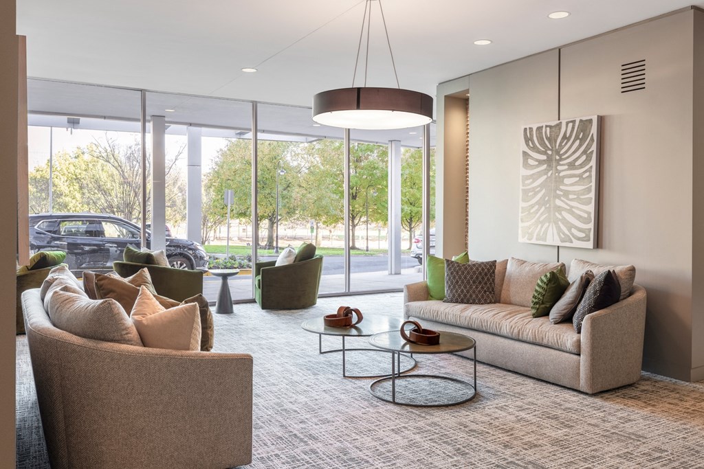 a living room with couches and chairs and a table