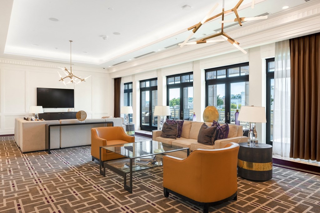 a living room filled with furniture and a large window