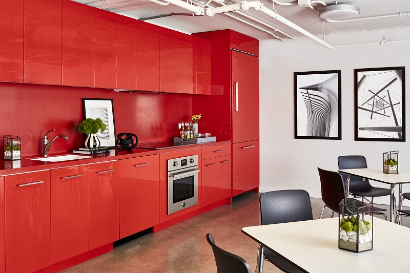 a kitchen with red cabinets and a table and chairs