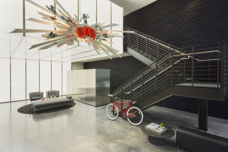 a living room with a bike and a ceiling light