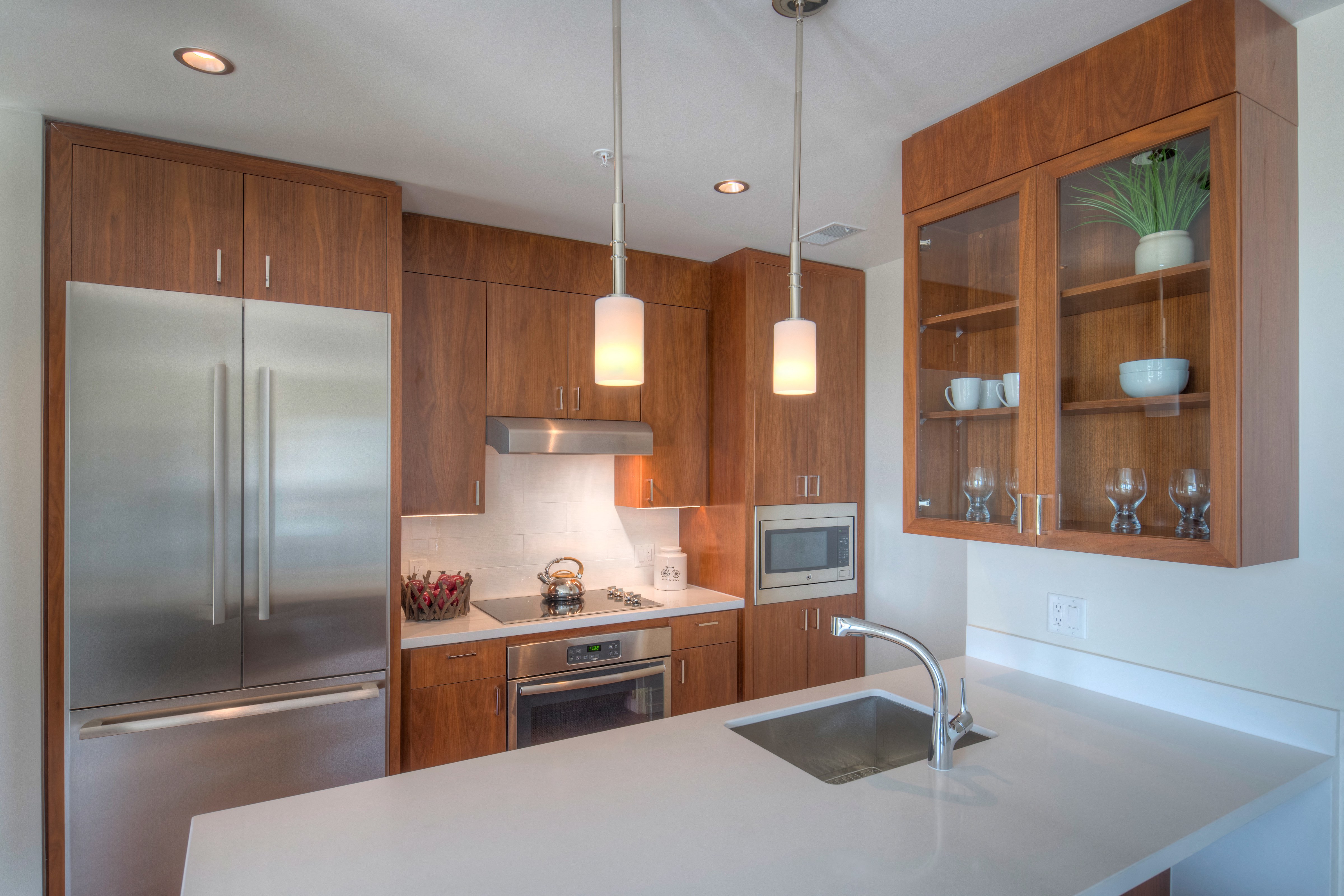 a kitchen with wooden cabinets and stainless steel appliances