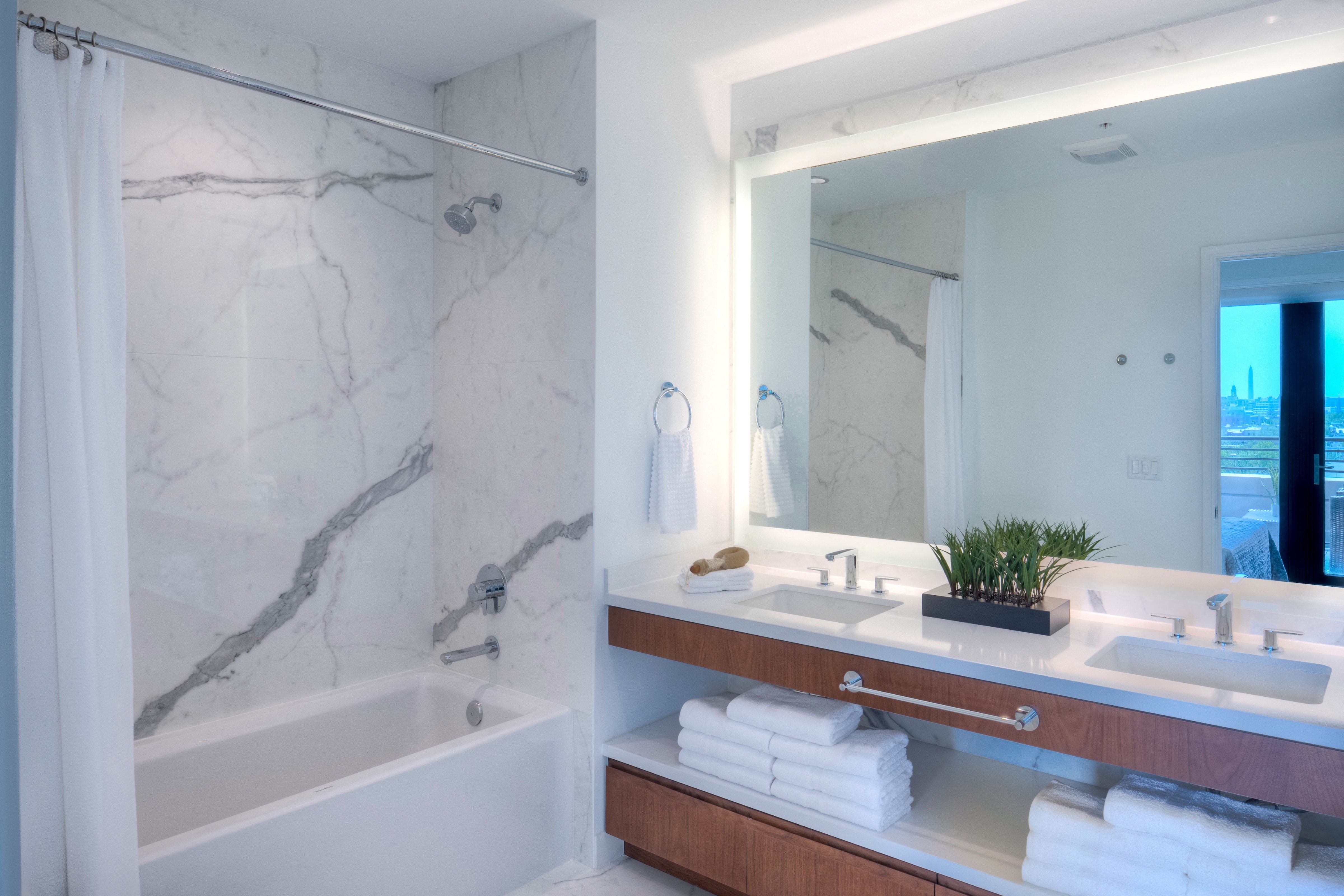 a bathroom with a tub and a sink and a mirror