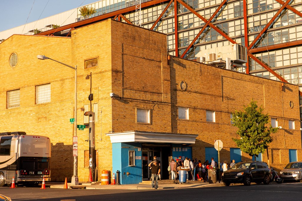 a city street with a brick building and a bus
