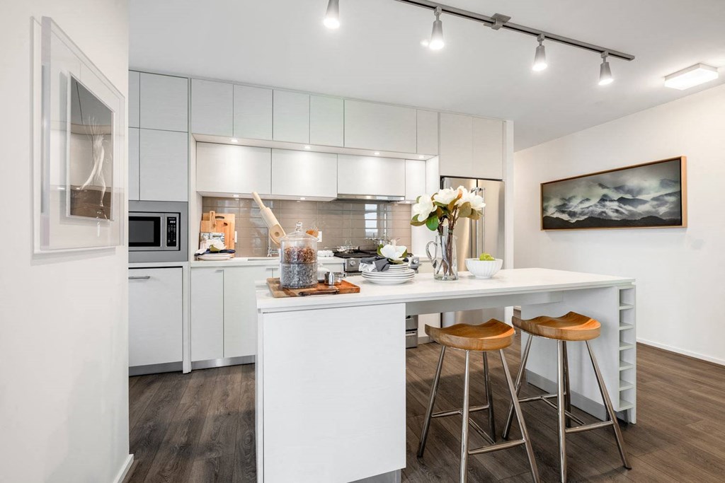 a kitchen with white cabinets and a counter top